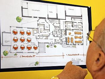 Franz-Josef Zeheter studiert die Pläne ganz genau: Rechts der aktuelle Umbau, links der eventuelle An- und Neubau in den Pfarrgarten hinein. Foto: Kestel