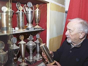 Noch rund 100 Trophäen und Pokale befinden sich in verschiedenen Vitrinen im Vereinslokal Göller. Der Zeiler Privatkegelclub "Goldene 13" möchte diese aus Platzgründen nun verschenken. Vorsitzender Anton Brüger schaut hier einen besonders alten Pokal an.  Foto: Ralf Naumann