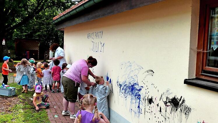 Die Kinder durften mit Pinsel und Farbe die Außenfassade des Kindergartens verschönern, bevor dieser abgerissen wird.