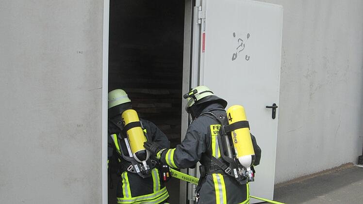 Atemschutzträger müssen sich wegen der fiktiven Rauchentwicklung auf Knien zu den Vermissten vorarbeiten.   Foto: Winfried Ehling