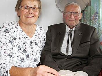 Tochter Monika Kotschenreuther zündet eine Kerze für ihren Vater an: Wilhelm Schmitt feierte 80. Geburtstag, die Tochter wurde am selben Tag 55. Foto: Sonny Adam