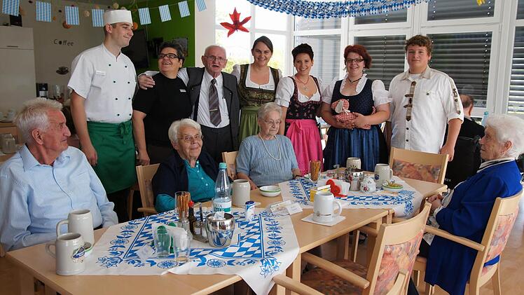 Karmen Vecek-Ukovic (hinten 2. v. l.), Johann Seubert (3. v. l.) und Ulrike Fink (4. v. l.) feiern mit Bewohnern und Kollegen ein zünftiges Oktoberfest. Foto: Heike Reinersmann