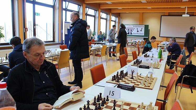 Eine Szene zwischen dem Geschehen: Karl-Heinz Jacob (l.) von der SG Sonneberg nutzt die Zeit seiner Spielpause zum Schmökern. Foto: Häggberg