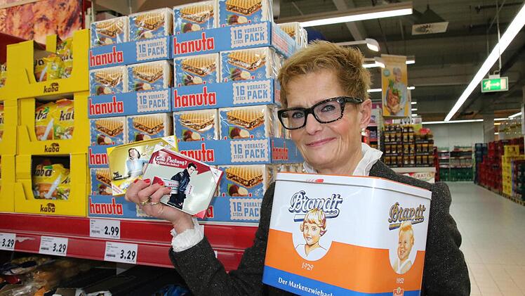 Hausleiterin Agnes Kalb-Seng zeigt Waren mit Retro-Verpackungen.