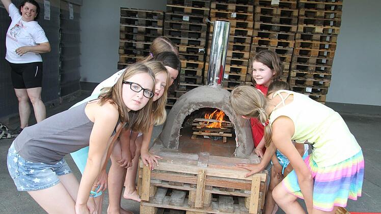 Das Feuer lodert im Ofen - wenn es heiß genug ist, wird die selbst gemachte Pizza hineingeschoben.