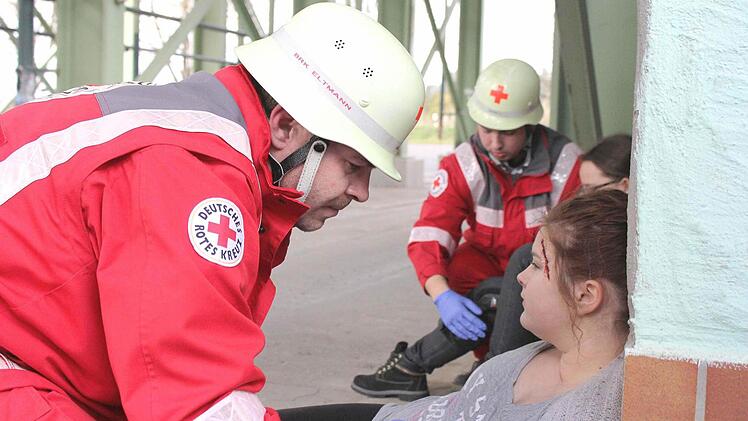 Unter den grünen Silos haben Sanitäter zwei schwer am Kopf verletzte Personen gefunden, die zu einer sechsköpfigen Besuchergruppe gehören. Alexander Weisensel (links) und sein Kollege kümmern sich.