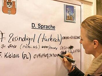 Joanna Kielan trägt sich beim Runden Tisch zum Thema Asyl als ehrenamtliche Helferin ein: "Ich könnte die Deutsche Sprache vermitteln." Foto: Werner Vogel