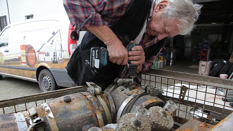 Robert Fleischmann bohrt vorsichtig den Korken des Whiskyfasses auf. Foto: Mathias Erlwein