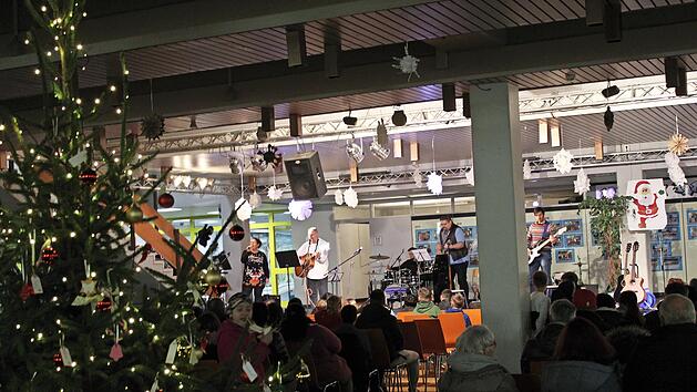 Die HOS-Lehrerband rockte inmitten der weihnachtlich geschm&uuml;ckten Aula.