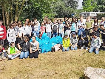 Die Sch&uuml;ler der f&uuml;nften und sechsten Klasse der Herzog-Otto-Mittelschule aus Lichtenfels r&auml;umten den M&uuml;ll bei der Aktion Ramadama am Badesee Oberwallenstadt auf und sammelten achtlos weggeworfenen M&uuml;ll ein.  Foto: