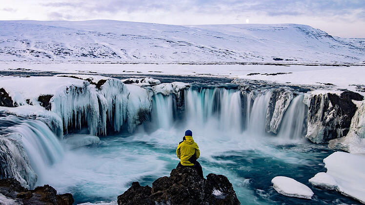 Adventurous man at Godafoss, Iceland in winter