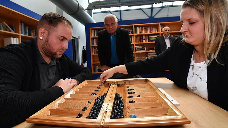 Opa Jurij beobachtet, wie seine Enkelin Anna sich beim Toguz Kumalak gegen Online-Gamer Edgar schlägt. Foto: Ronald Rinklef