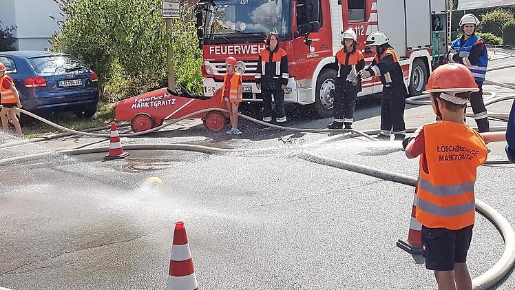 Die Kinder versuchen, den Ball mit dem Wasserstrahl ins gegnerische Tor zu spülen.  Fotos: Matthias Herzog