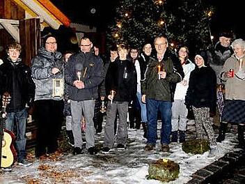 Vor der Krippe am Dorfplatz wurde das Friedenslicht von Bethlehem weitergegeben und in die Nacht getragen. Fotos: Günther Geiling