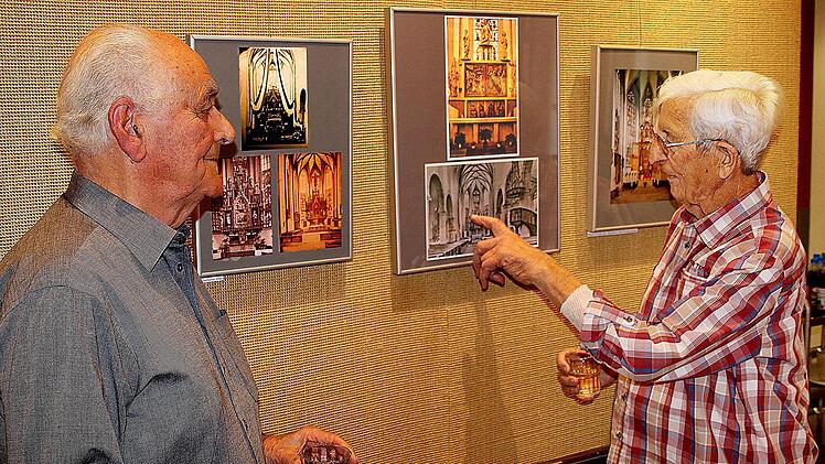 "Glocken und Altäre": Toni Hiller (rechts) zeigt im Seniorenzentrum St. Elisabeth historische Bilder aus der Geschichte der Pfarrkirche Maria  Magdalena. Links Ausstellungsmacher Horst Kreutz. Foto: Dieter Britz