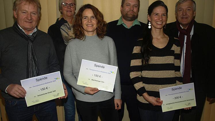 Das Therapiezentrum Blaßdörfer unterstützt zu Weihnachten soziale bzw. kirchliche Projekte. Schecks über insgesamt 500 Euro überreichte Thorsten Blaßdörfer (Mitte) an (von links) Stefan Labus (Kindertafel Schweinfurt), Dagmar Ziegler und Marina Schachenmayer-Wiesend (Tafel Bad Kissingen) sowie Susanne Blaßdörfer und Pfarrer Philipp Klein (Kirchenbauverein Oerlenbach). Foto: Stefan Geiger