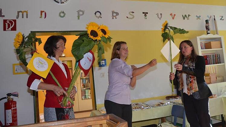 Für das Lehrerkollegium überreichten Kerstin Schmidt- Müller(links) und Melanie Haberzettl Wunsch-Sonnenblumen an die neue Schulleiterin Gisela Gebert-Hartenstein (rechts). Foto: Karl-Heinz Hofmann