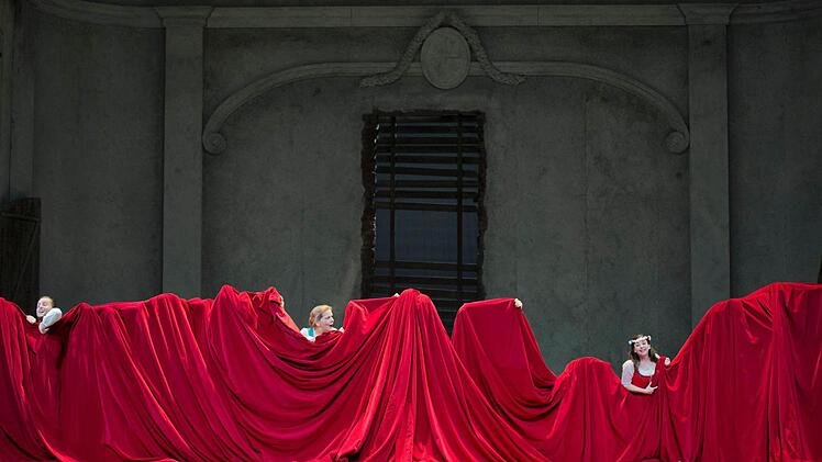 Ein großer roter Theatervorhang ist ein wesentliches Requisit der Neuisnzenierung.