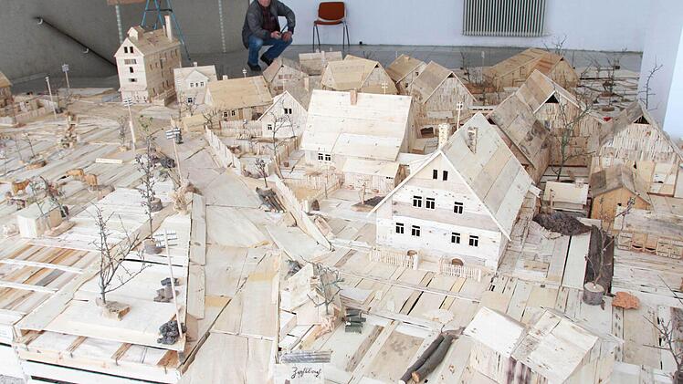 Ein Modell des Dorfes Zahlbach Ende der 40er Jahre, das aus Holzkisten entstanden ist, zeigt Karl Voll im Schaufenster des ehemaligen Eisenwarengeschäfts in der Forstmeisterstraße 29. Foto: Carmen Schmitt