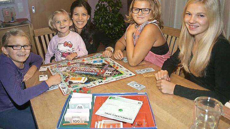 Alejandra Ales aus El Salvador fühlt sich in ihrer Gastgeberfamilie in Oerlenbach wunderbar geborgen. Auf unserem Foto spielt sie Monopoly mit von links Maxima (links) sowie Anya und Kira (rechts), während sich die fünfjährige Mara auf Alejandras Schoß wohl fühlt.  Foto: Stefan Geiger