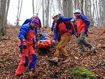 In einer Gebirgstrage schafften die Retter der Bergwacht das Opfer den steilen Hang hinunter.