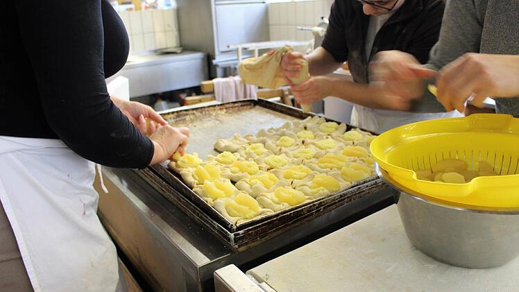 Viele Hände fertigen routiniert die Gebäckstücke an. Foto: Julia Raab