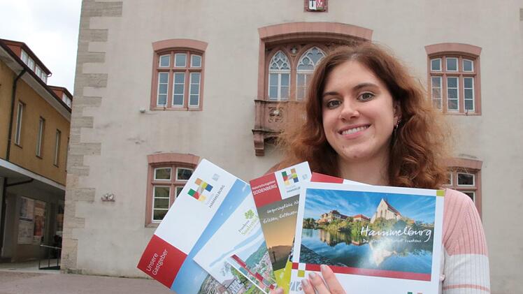 Jede Menge Prospekte weisen auf die Schönheiten der Stadt Hammelburg und der Region drumherum hin. Verena Dotzel, seit einem Jahr Leiterin der Tourist-Info, zeigt einige davon. Foto: Ralf Ruppert