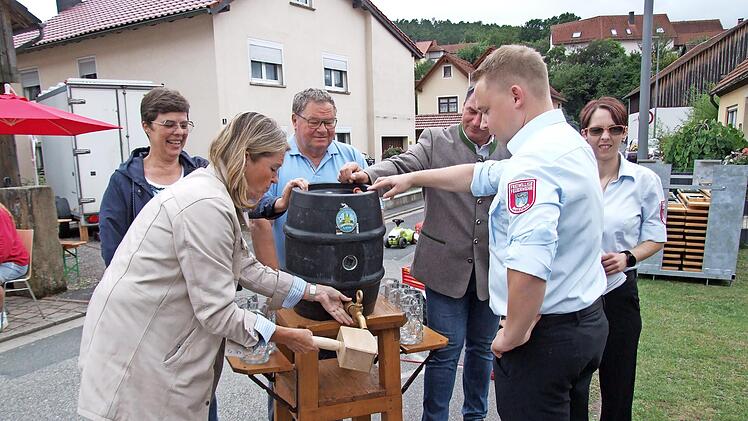 Zweite Bürgermeisterin Sabine Rießner sticht das erste Fass Bier an, unterstützt von Elke Werner, Drittem Bürgermeister Matthias Söllner, Bernd Krauß, Vorsitzendem Tobias Gareis und Kommandantin Christina Vogel.