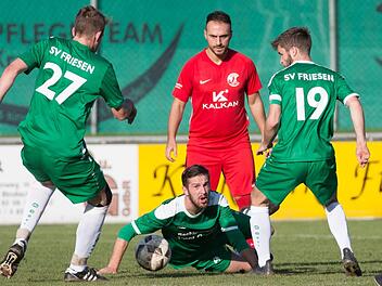 Friesens Abwehrspieler Andreas Baier wirft sich in den Ball, auf den der zweifache Torsch&uuml;tze G&ouml;khan Aydin (rotes Trikot) wartet.  Foto: Heinrich Wei&szlig;