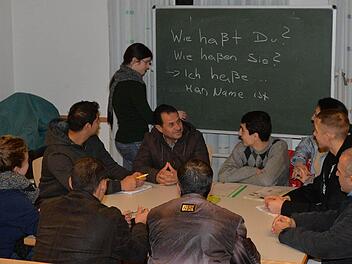 Die Studentinnen Gabrina Mätzke (an der Tafel) und Katja Winter (vorne links) geben Asylbewerbern Deutschunterricht. Foto: Ronald Rinklef