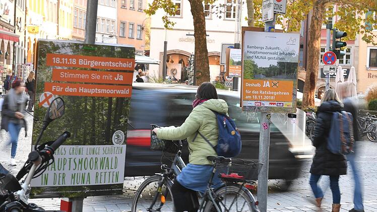 Gegner und Befürworter des Gewerbeparks haben überall in der Stadt plakatiert, Konversionsamtsleiter Harald Lang informiert in der Pop-Up-Ausstellung der Stadt (unten links), Erich Spranger im Infoladen der Bürgerinitiative. Fotos: Ronald Rinklef