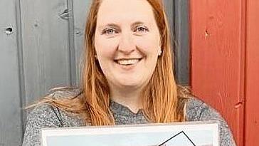 Alexandra Rehm trägt das Plakat zum Kinder- und Jugendflohmarkt am 5. September.