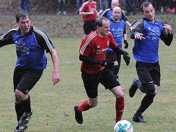 Die wetterbedingten Qualen des Spieltags stehen dem Oberthulbaer Markus Markert (am Ball) und dem Obereschenbacher  Florian Holzinger (rechts) ins Gesicht geschrieben.ssp