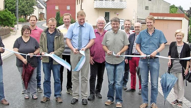 Gemeinsam vollzogen Bürgermeister Michael Keilich (CSU), Gemeinderäte, Bauamtsleiter Stefan Dümmlein, bauleitender Ingenieur Klaus Müller (IVS Kronach ) sowie Jürgen und Christian Carl (Franz Hofmann Bau Sonnefeld) als Repräsentanten der am langwierigen Ausbau beteiligten Baufirma den obligatorischen Bandschnitt.