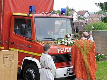 Auf dem Kirchenvorplatz segnet Kaplan Philipp Tropf das neue Fahrzeug der Schondraer Wehr.  Fotos: Oswald Türbl
