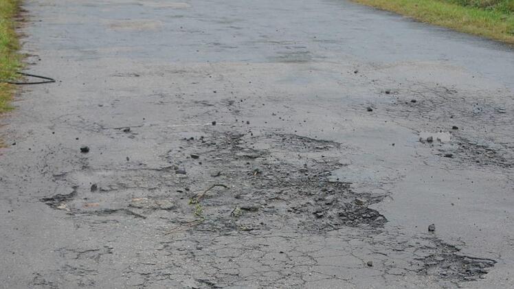Eher einem Schweizer Käse als einer Gemeindeverbindungsstraße gleicht derzeit der Mirsdorfer Weg  in Neukirchen. Vor Wintereinbruch sollen dieschadhaften Stellen geschlossen werden. Foto: Martin Rebhan
