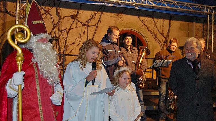 Nikolaus, Christkind und Engel eröffneten mit Veranstalter Klaus Frischat die erste Aschacher Schlossweihnacht; dahinter das Quartett der Blaskapelle Aschach