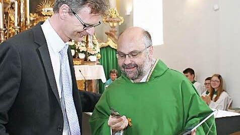 Der evangelische Pfarrer Andreas Steinbauer (links) gab seinem scheidenden katholischen Mitbruder ein "Überlebensbesteck" mit auf den Weg "in die Fremde".