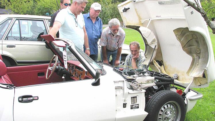 Christian Fraundorfer aus Mühlhausen (Landkreis Erlangen-Höchstadt, 2. von links) gab im wahrsten Sinnes des Wortes einen Einblick in seinen Triumph "Spitfire 1500", Baujahr 1980. Fotos: Ralf Naumann