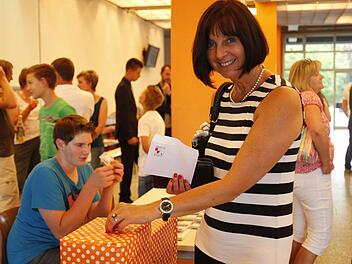 Sichtlich erfreut übe die Wertsteigerung ihrer Aktie ist hier Marion Gießmann, Sekretärin an der Schule, die hier auch die Spendenaktion der Schüler von ihrem Reingewinn unterstützt. Foto: Günther Geiling