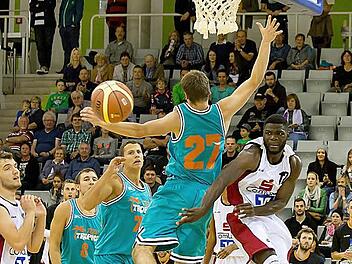 Die Coburger Basketballer (weiße Trikots) spielten mit den Würzburgern Katz und Maus. In dieser Szene bereitet Nicolau Dilukila (Nummer 12) hinter dem Rücken des Würzburgers einen Korb vor. Foto: Albert Höchstädter