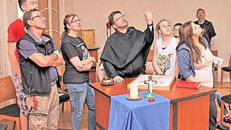 Die Deckengemälde mit den lateinischen Inschriften im Stucksaal des Jugendhauses sind wirklich sehenswert. Pater Jeremias erläutert sie den Ministranten. Foto: Dieter Britz