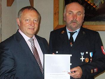 Für seine Verdienste bei der Feuerwehr nahm Thomas Schipper (rechts) das Ehrenzeichen des Landesverbands von Landrat Thomas Bold entgegen. Winfried Ehling