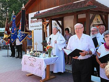 Den Gottesdienst bei der Ambrosiusfeier am Bienenhaus zelebrierte Augustinerpater Winfried Pfeuffer (Mitte). Die Liedertafel gab dem Gottesdienst einen feierlichen Rahmen. Auch eine Fahnenabordnung war dabei. Foto: Dieter Britz