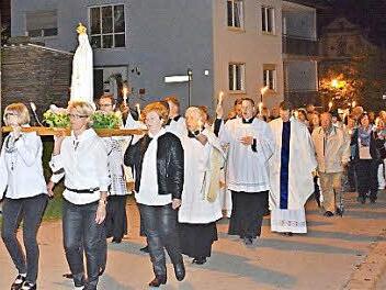 Hunderte von Lichtern säumten die Straßen, auf der die Lichterprozession zur Ehren der Muttergottes von Fatima stattfand. Frauen trugen das Bild der Gottesmutter, das mit vielen Blumen geschmückt war. Dahinter die Geistlichkeit.  Foto: Hanns Friedrich