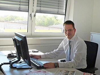 Karge Schaltzentrale: Rolf Beyer sitzt in seinem neuen Büro in der Geschäftsstelle der Brose Baskets an seinem Schreibtisch.  Foto: Udo Schilling