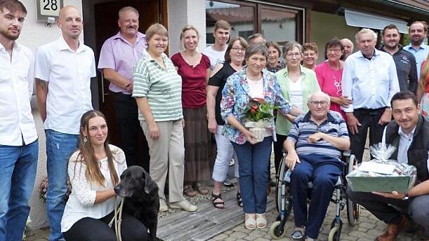Irmgard (stehend, mit Blumen) und Wilfried Paroch (im Rollstuhl) feierten goldene Hochzeit im Kreis der Familie; mit im Bild (rechts, sitzend) Zweiter Bürgermeister Martin Döring
