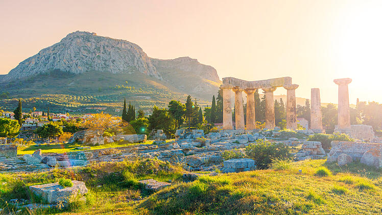 Ruins of temple of Apollo at sunset, Ancient Corinth in Greece