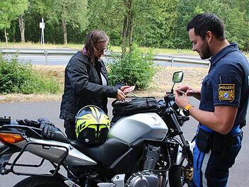 Maximilian Hofmann von der Verkehrspolizeiinspektion Schweinfurt-Werneck kontrolliert die Fahrzeugpapiere von Friederike Späh. Alles in Ordnung, bei ihr gab es keine Beanstandungen. Thomas Malz