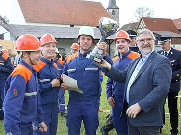 Die Siegermannschaft aus den Jugendfeuerwehren Froschgrund/Meilschnitz erhielt den großen Pokal von Landrat Michael Busch überreicht. Von links: Niklas Klaus, Mark Langbein, Nick Eichhorn-Ciopala und Sinan Turhan. Foto: Michael Stelzner